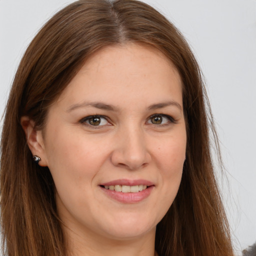 Joyful white young-adult female with long  brown hair and brown eyes