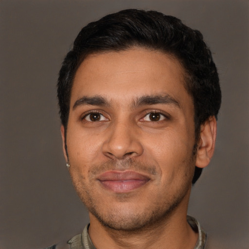 Joyful latino young-adult male with short  black hair and brown eyes