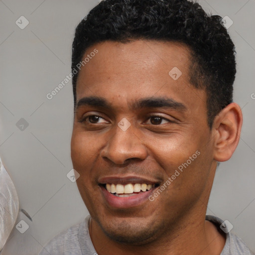 Joyful latino young-adult male with short  black hair and brown eyes