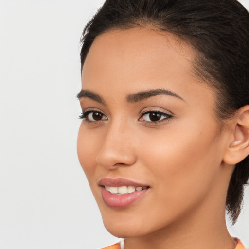 Joyful latino young-adult female with medium  brown hair and brown eyes