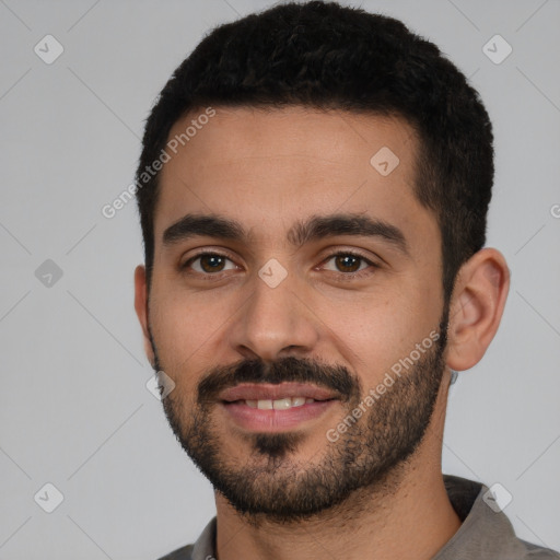 Joyful white young-adult male with short  black hair and brown eyes