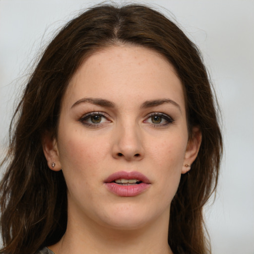 Joyful white young-adult female with long  brown hair and green eyes