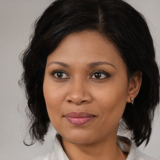Joyful black young-adult female with medium  brown hair and brown eyes