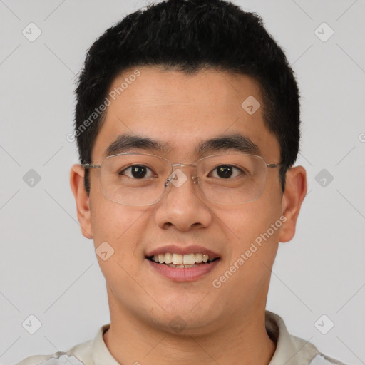 Joyful asian young-adult male with short  black hair and brown eyes