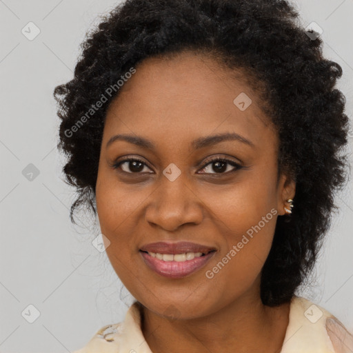 Joyful black adult female with long  brown hair and brown eyes