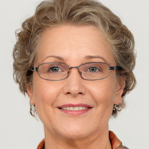 Joyful white adult female with medium  brown hair and blue eyes