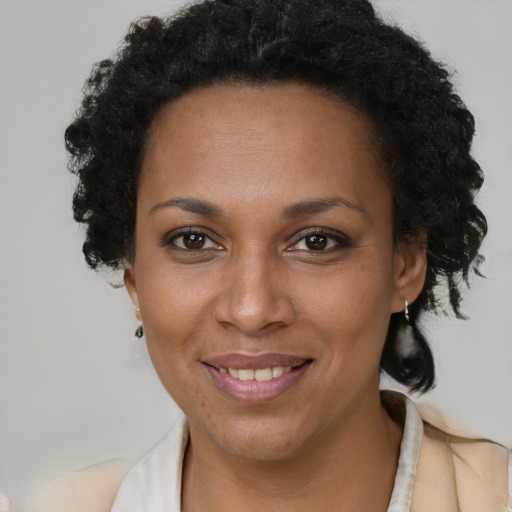 Joyful black adult female with short  brown hair and brown eyes