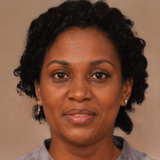 Joyful black adult female with short  black hair and brown eyes
