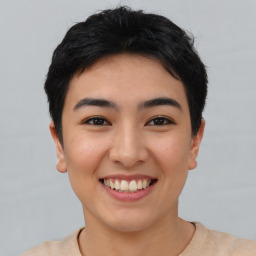 Joyful asian young-adult female with short  black hair and brown eyes