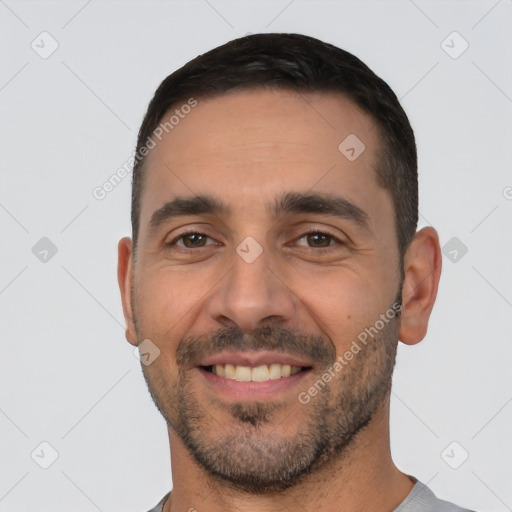 Joyful white young-adult male with short  black hair and brown eyes