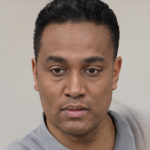 Neutral black young-adult male with short  black hair and brown eyes