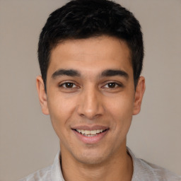 Joyful white young-adult male with short  black hair and brown eyes