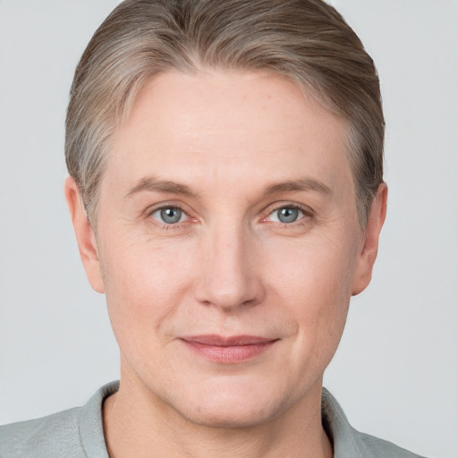 Joyful white adult female with short  brown hair and grey eyes