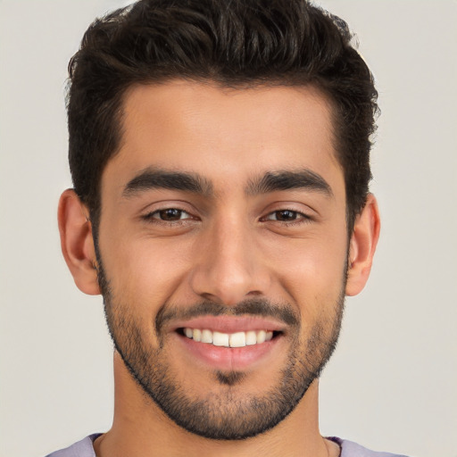 Joyful white young-adult male with short  black hair and brown eyes