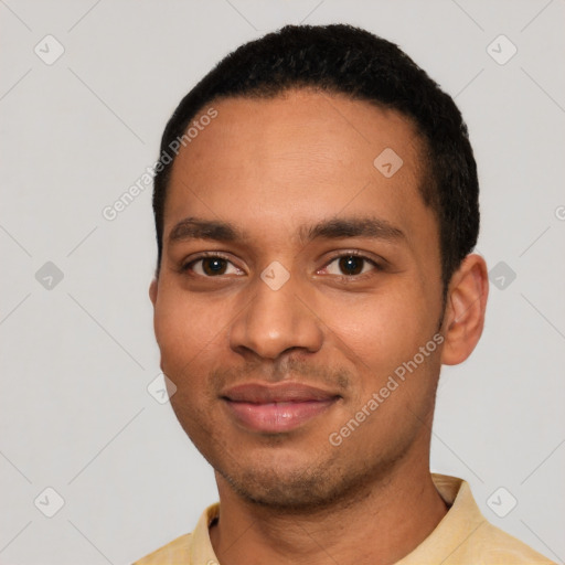 Joyful black young-adult male with short  black hair and brown eyes