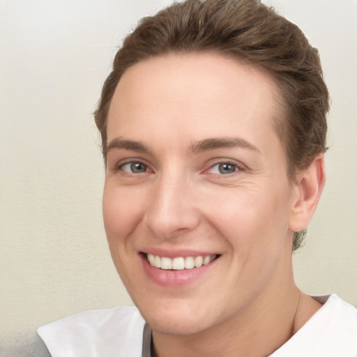 Joyful white young-adult female with short  brown hair and grey eyes