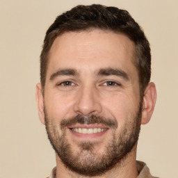 Joyful white young-adult male with short  brown hair and brown eyes