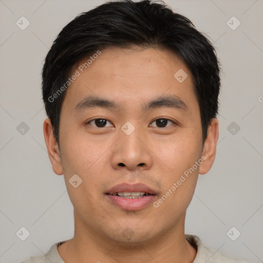 Joyful asian young-adult male with short  brown hair and brown eyes