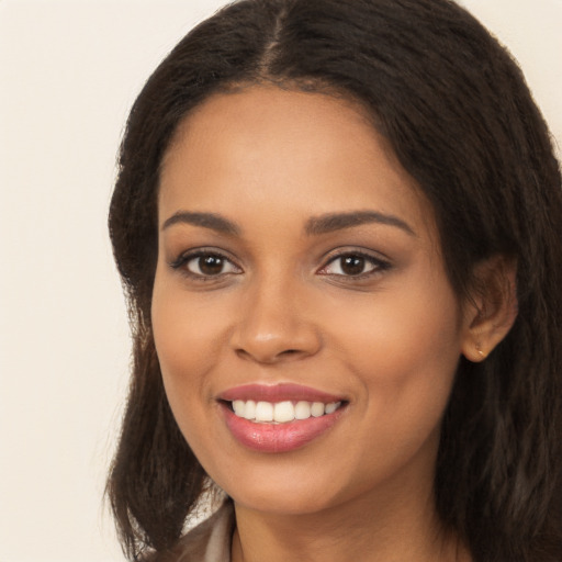 Joyful latino young-adult female with long  brown hair and brown eyes