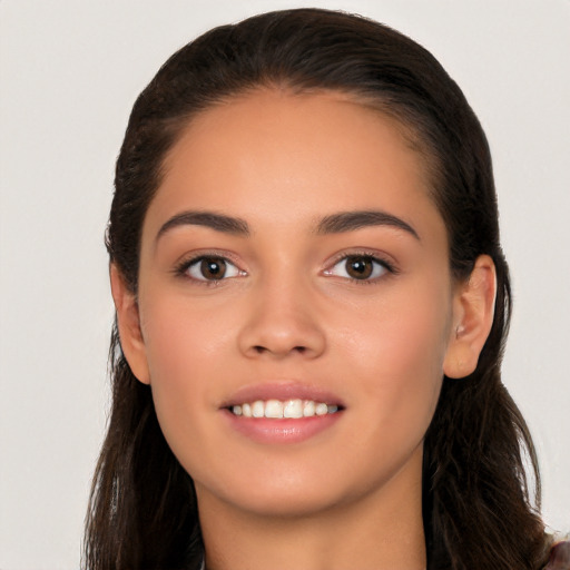 Joyful white young-adult female with long  brown hair and brown eyes