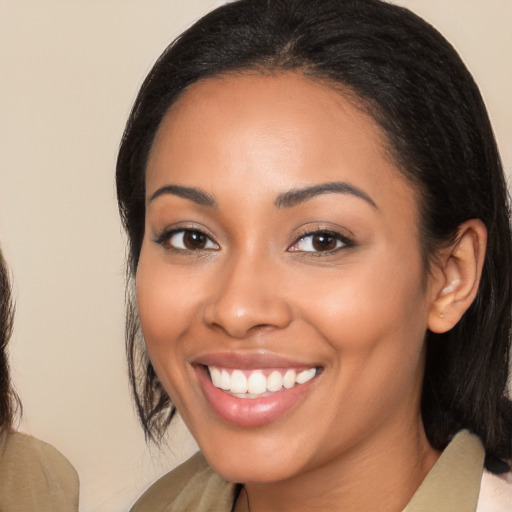 Joyful latino young-adult female with medium  brown hair and brown eyes