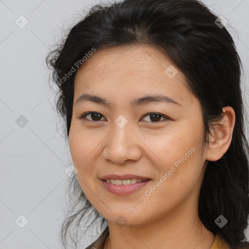 Joyful latino young-adult female with long  brown hair and brown eyes