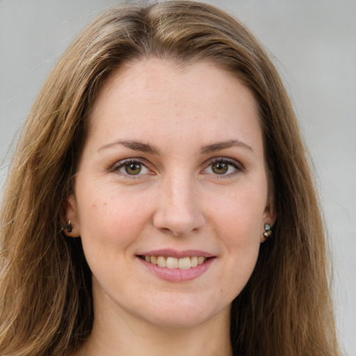 Joyful white young-adult female with long  brown hair and green eyes