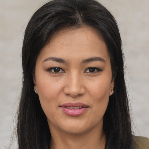 Joyful latino young-adult female with long  brown hair and brown eyes