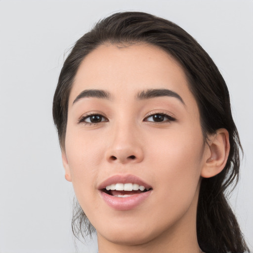 Joyful white young-adult female with medium  black hair and brown eyes