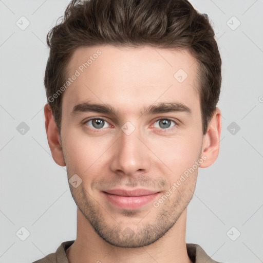 Joyful white young-adult male with short  brown hair and grey eyes