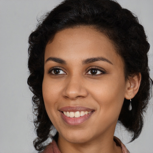Joyful latino young-adult female with medium  brown hair and brown eyes
