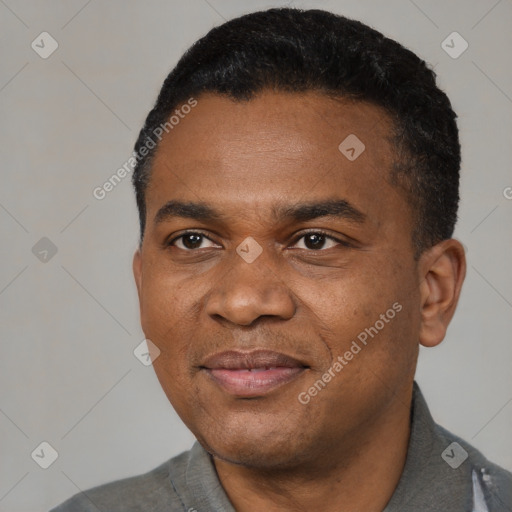 Joyful black young-adult male with short  black hair and brown eyes