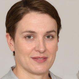 Joyful white adult female with short  brown hair and grey eyes