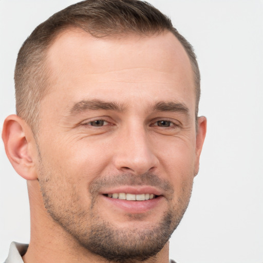 Joyful white adult male with short  brown hair and brown eyes