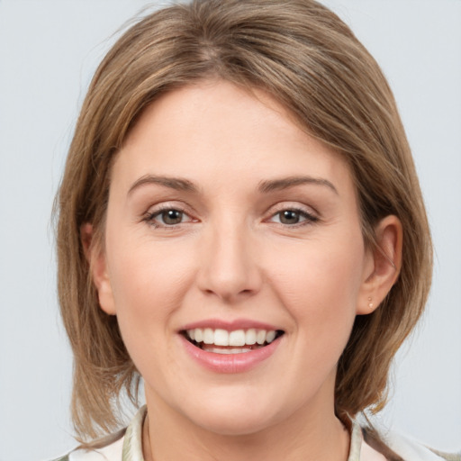 Joyful white young-adult female with medium  brown hair and grey eyes