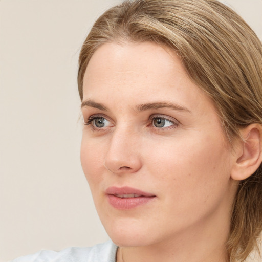 Joyful white young-adult female with medium  brown hair and blue eyes