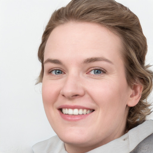 Joyful white young-adult female with medium  brown hair and blue eyes