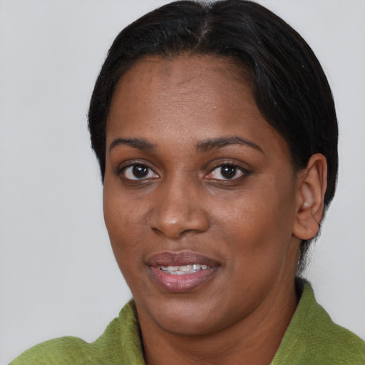 Joyful black young-adult female with short  brown hair and brown eyes