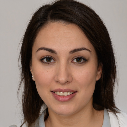 Joyful white young-adult female with medium  brown hair and brown eyes