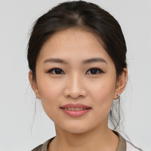 Joyful asian young-adult female with medium  brown hair and brown eyes