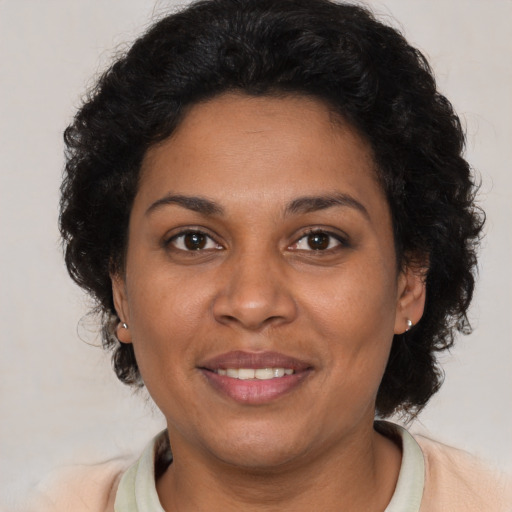 Joyful latino adult female with short  brown hair and brown eyes