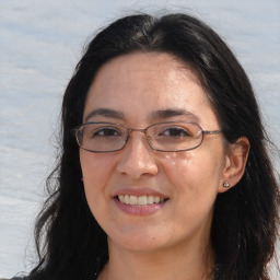 Joyful white adult female with long  brown hair and brown eyes