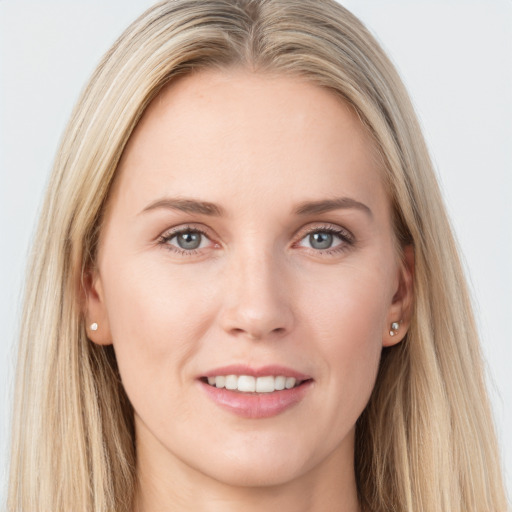 Joyful white young-adult female with long  brown hair and blue eyes