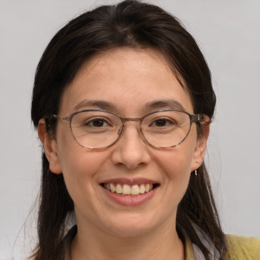 Joyful white adult female with medium  brown hair and brown eyes