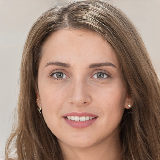 Joyful white young-adult female with long  brown hair and grey eyes