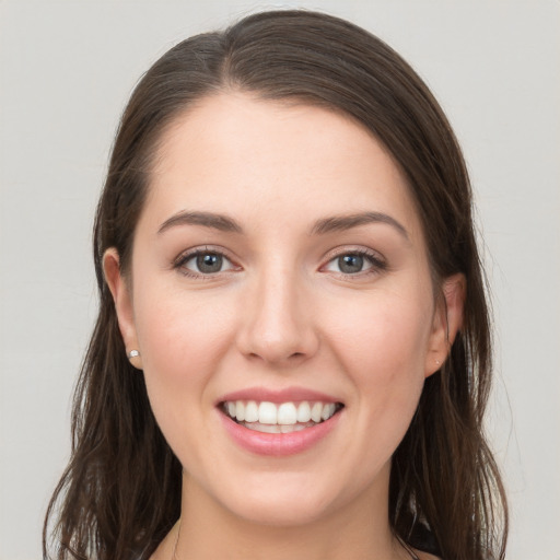 Joyful white young-adult female with long  brown hair and grey eyes