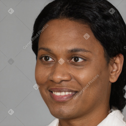 Joyful black young-adult female with short  black hair and brown eyes