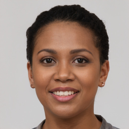 Joyful latino young-adult female with short  brown hair and brown eyes