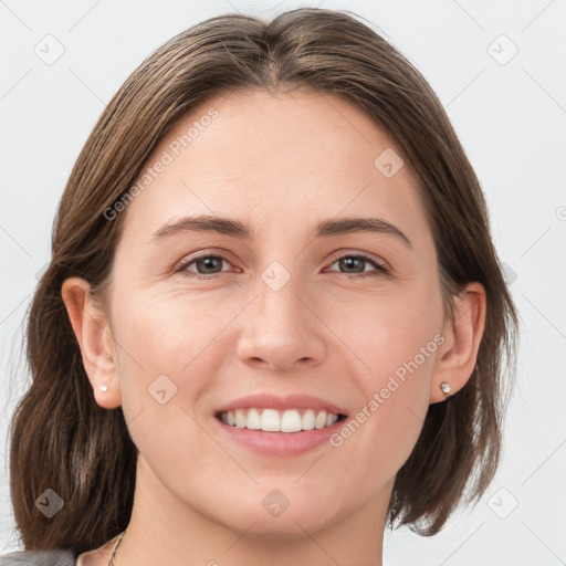 Joyful white young-adult female with medium  brown hair and grey eyes