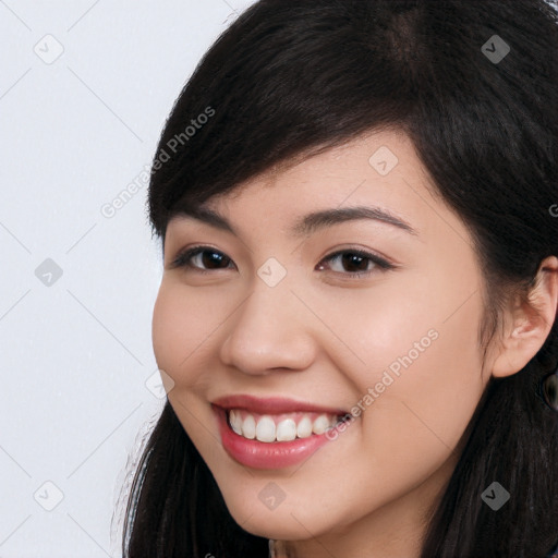 Joyful white young-adult female with long  black hair and brown eyes